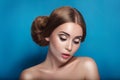 Attractive mysterious young woman with double hair bun in Princess Leia hairstyle looks towards the camera Royalty Free Stock Photo