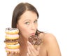 Attractive Natural Happy Young Woman Holding a Pile of Iced Donuts