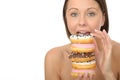 Attractive Natural Young Woman Holding a Pile of Iced Donuts