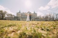 Attractive newlywed couple embracing at green sunny lawn near beautiful ruined baroque palace. Loving groom and charming Royalty Free Stock Photo