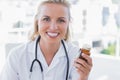 Attractive nurse holding a medicine jar Royalty Free Stock Photo