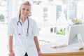 Attractive nurse leaning on desk Royalty Free Stock Photo