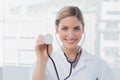 Attractive nurse showing her stethoscope Royalty Free Stock Photo