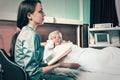 Attractive nurse in uniform is reading a book for her patient Royalty Free Stock Photo