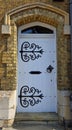 Attractive Old White Door with decorative hinges. Royalty Free Stock Photo