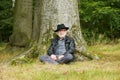 Attractive older man sitting under tree Royalty Free Stock Photo