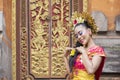 Attractive pendet dancer smiling in temple door Royalty Free Stock Photo