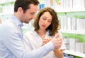 Attractive pharmacist advising a customer