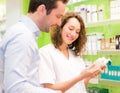 Attractive pharmacist advising a patient