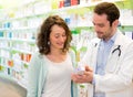 Attractive pharmacist advising a patient