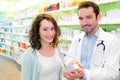 Attractive pharmacist advising a patient