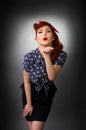 Attractive pin up girl blowing a kiss Royalty Free Stock Photo