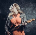 Attractive plump rocker woman with electric guitar Royalty Free Stock Photo