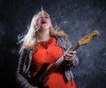 Attractive plump rocker woman with electric guitar Royalty Free Stock Photo