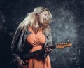 Attractive plump rocker woman with electric guitar Royalty Free Stock Photo