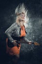 Attractive plump rocker woman with electric guitar