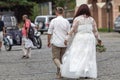 Attractive plus size bride in white dress on walk with groome