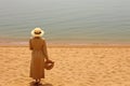 Attractive plus-sized woman enjoying a solitary stroll along the picturesque beach