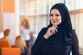 Attractive portrait of young muslim woman with black hijab at the office
