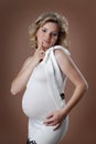 Attractive pregnant girl against beige background