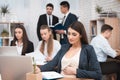 Attractive pregnant girl is working in office with colleagues. Pregnant businesswoman in workspace. Pregnant girl Royalty Free Stock Photo