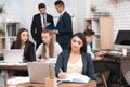 Attractive pregnant girl is working in office with colleagues. Pregnant businesswoman in workspace. Maternity. Royalty Free Stock Photo