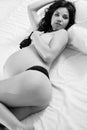 attractive pregnant woman in bed in sexy underwear.