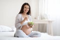 Attractive pregnant woman eating healthy meal at home Royalty Free Stock Photo