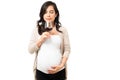 Caucasian woman deciding to drink alcohol during her pregnancy Royalty Free Stock Photo