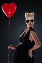 Attractive pregnant woman with a red balloon. Royalty Free Stock Photo