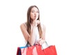 Attractive pretty shopaholic with shopping bags making a silence