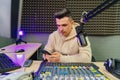 a radio host with phone during break on a broadcast in a radio studio. Royalty Free Stock Photo