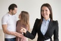 Attractive real estate agent holding keys to apartment, property