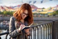 Attractive red-haired girl organizes holiday events, thinking th Royalty Free Stock Photo