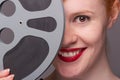 Attractive redhead with film reel