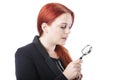 Attractive redhead holding a magnifying glass Royalty Free Stock Photo