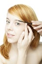 Attractive redhead woman applying mascara Royalty Free Stock Photo