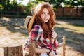 Attractive redhead young woman cowgirl standing outdoors Royalty Free Stock Photo