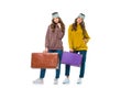 attractive retro styled twins standing with travel bags