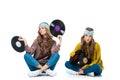 attractive retro styled young twins sitting with 12 inch vinyls