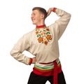 Attractive russian guy dancing in folk costume isolated on white