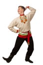 Attractive russian guy dancing in folk costume isolated on white