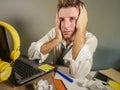 Attractive sad and desperate man in lose necktie looking messy and depressed working at laptop computer desk in business office pr Royalty Free Stock Photo