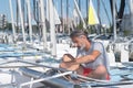 Attractive sailor rigging hobbie-cat before sailing course