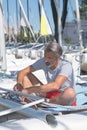 Attractive sailor rigging hobbie-cat before sailing course