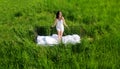 Attractive, satisfied pleased young, sexy, cute, brunette woman outdoors in bed, in white nightwear, on the meadow in the high