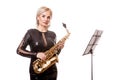 Attractive saxophonist woman playing at her musical instrument Royalty Free Stock Photo