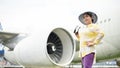 An attractive senior Asian lady in a summer outfit stands at the airport. summer vacation concept Royalty Free Stock Photo