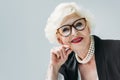 attractive senior lady with pearl necklace and eyeglasses,