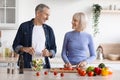 Attractive senior man and woman cooking together at home Royalty Free Stock Photo